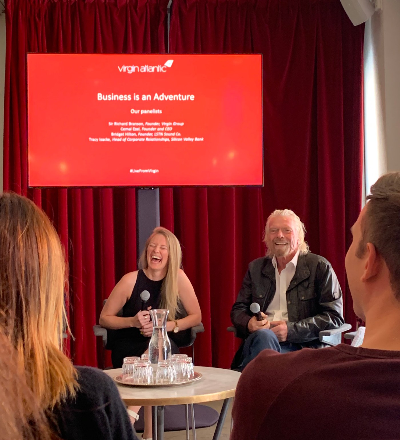 Bridget Hilton laughing with Sir Richard Branson on a Virgin Atlantic panel