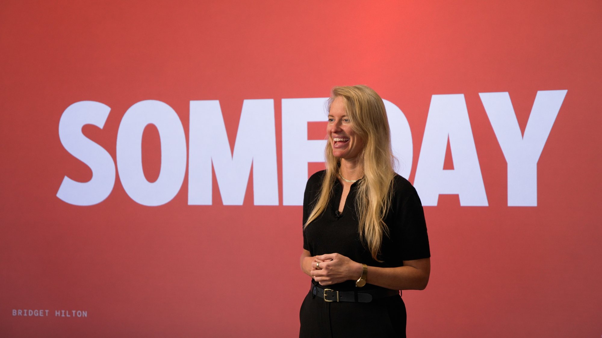 Bridget Hilton on stage in front of the word SOMEDAY