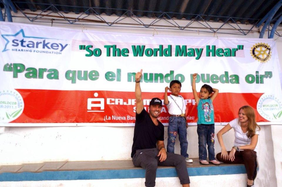 Bridget and Joe with kids at a Starkey Hearing Foundation mission