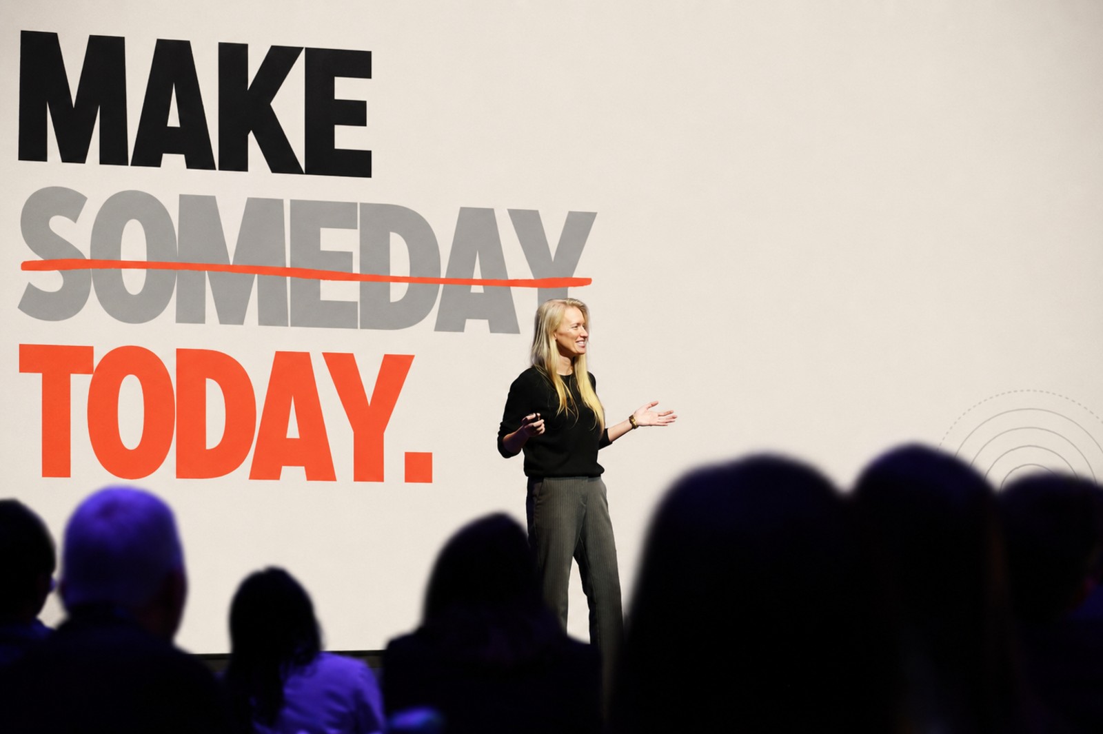 Bridget Hilton on stage in front of the Make Someday Today slide