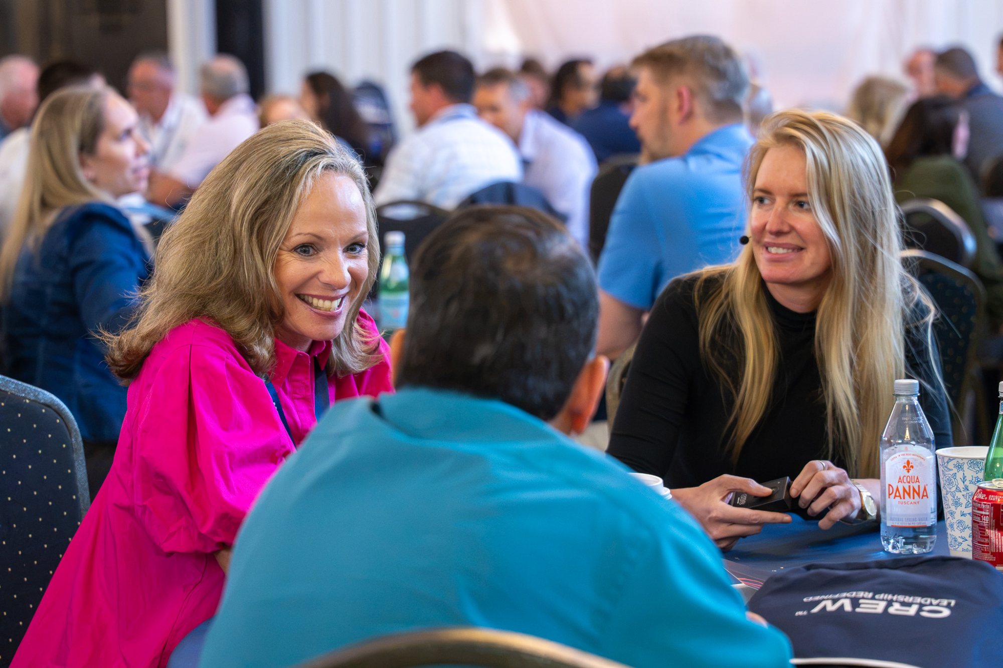 Participants laughing together at a table